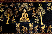 Wat Xieng Thong temple in Luang Prabang, Laos. Detail of the  intricate gold stencilling on black lacquer that decorate the walls of the sim.